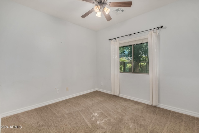 carpeted spare room with ceiling fan