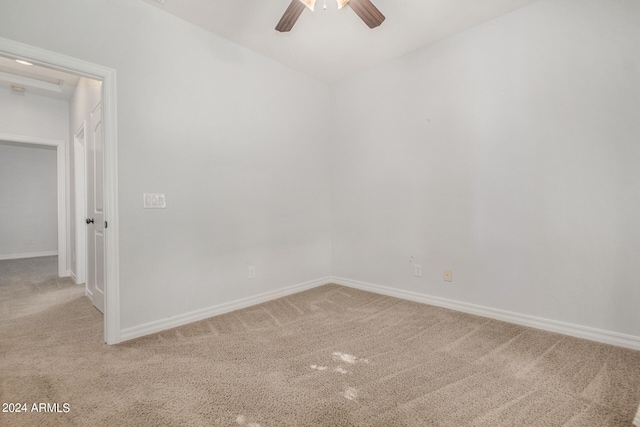 carpeted spare room with ceiling fan