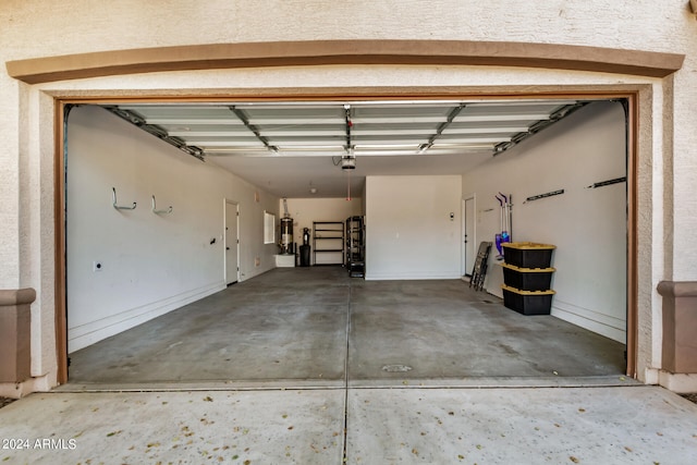 garage featuring a garage door opener and gas water heater