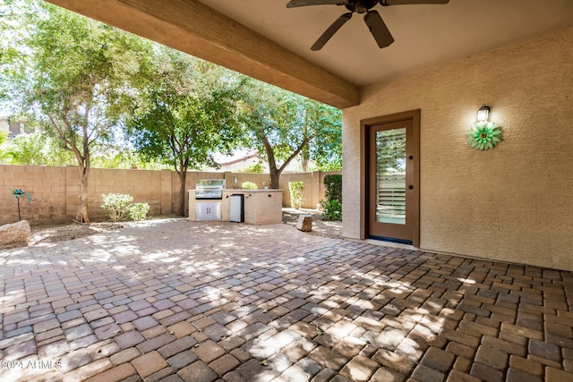 view of patio with exterior kitchen, grilling area, and ceiling fan