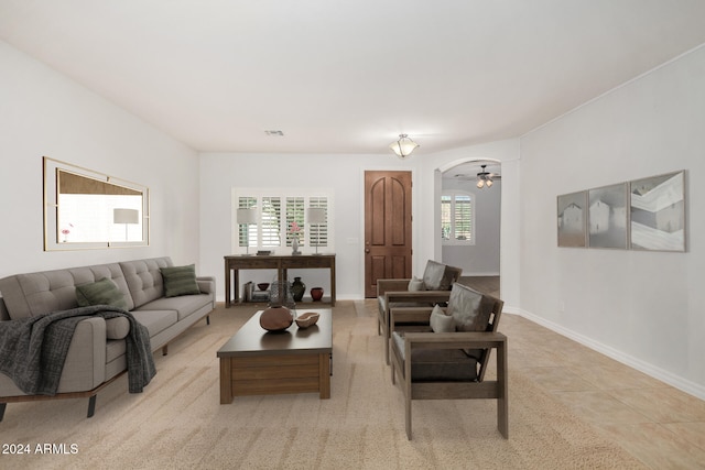 tiled living room featuring ceiling fan