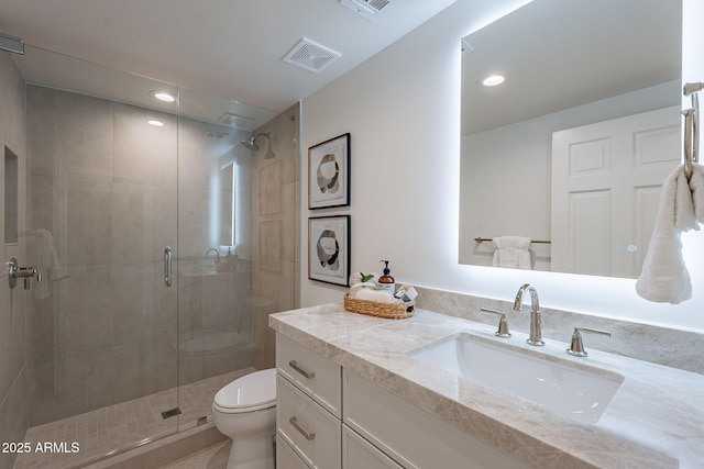 bathroom with toilet, vanity, and walk in shower