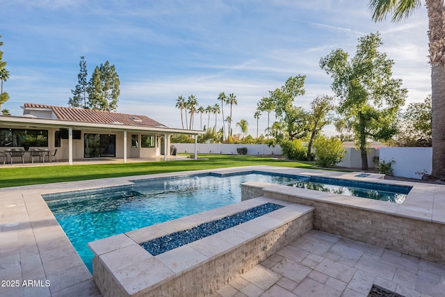 view of pool with an in ground hot tub, a patio area, a fire pit, and a lawn