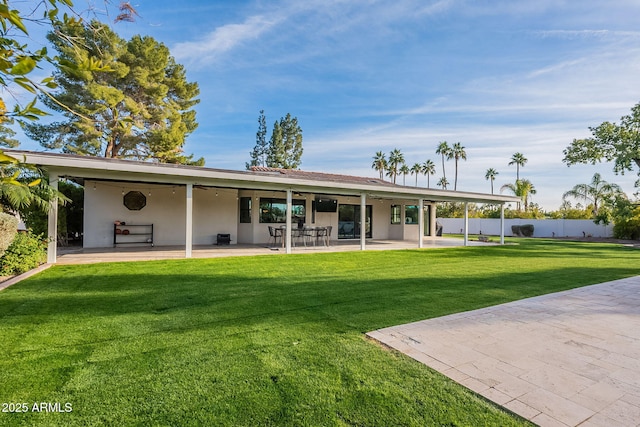 back of house featuring a patio area and a yard