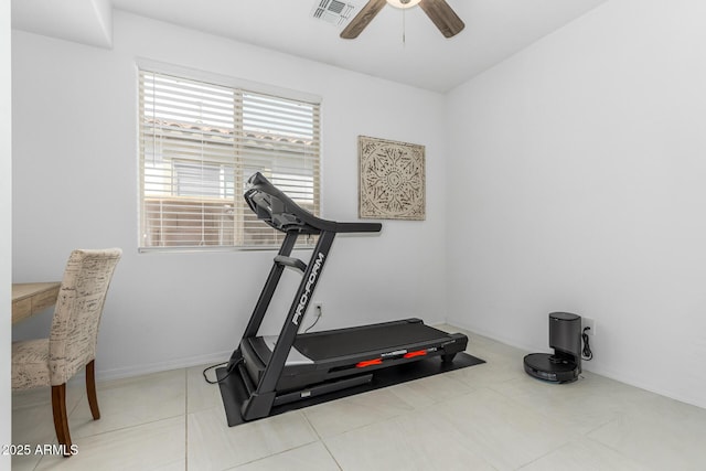 exercise area with baseboards, ceiling fan, visible vents, and tile patterned flooring