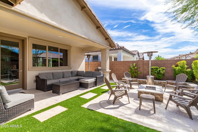 view of patio featuring an outdoor living space with a fire pit and fence