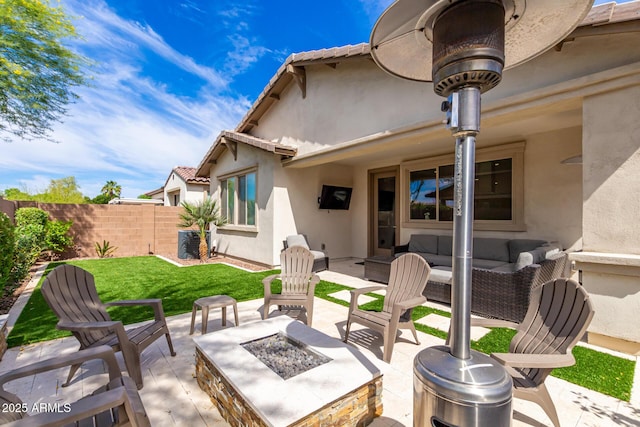 view of patio with an outdoor living space with a fire pit, fence, and central air condition unit