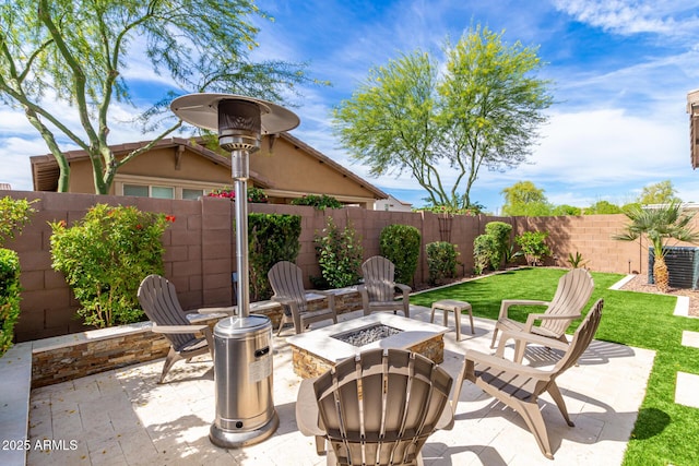 view of patio featuring a fenced backyard and a fire pit