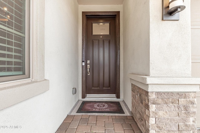 property entrance with stucco siding