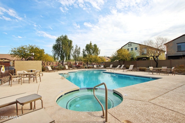 view of swimming pool with a patio area and a hot tub