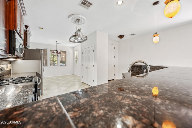 3850 E Geronimo St, Gilbert, AZ 85295 - kitchen featuring stainless steel appliances, light tile patterned flooring, hanging light fixtures, recessed lighting, and dark stone countertops