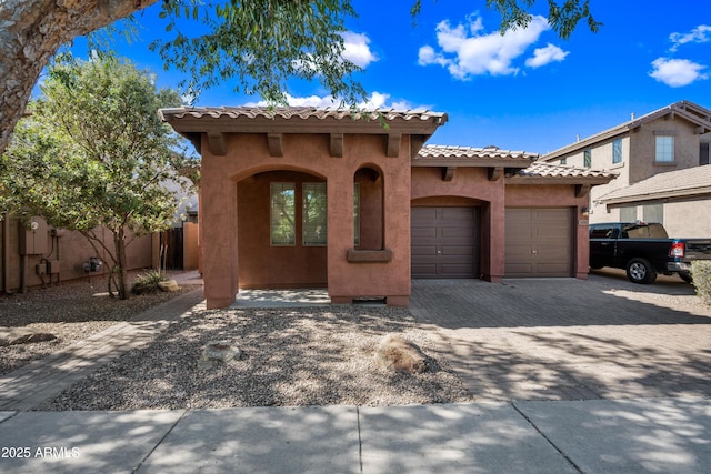 3850 E Geronimo St, Gilbert, AZ 85295 - mediterranean / spanish-style home featuring an attached garage, stucco siding, decorative driveway, and a tile roof