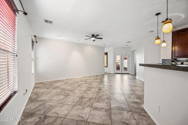 3850 E Geronimo St, Gilbert, AZ 85295 - unfurnished living room featuring a ceiling fan and baseboards