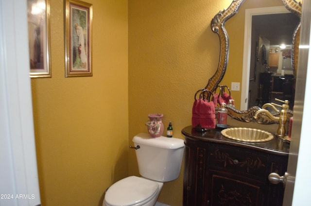 bathroom featuring toilet and vanity