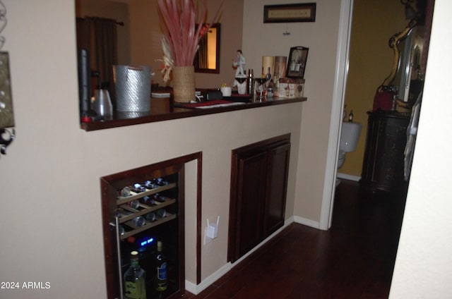 bar featuring hardwood / wood-style flooring and beverage cooler