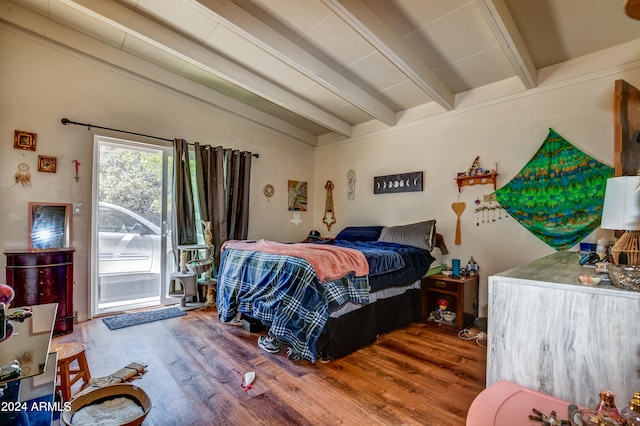 bedroom with access to outside, lofted ceiling with beams, and hardwood / wood-style floors