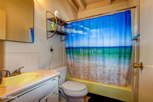 full bathroom with tile walls, shower / bathtub combination with curtain, vanity with extensive cabinet space, toilet, and tasteful backsplash