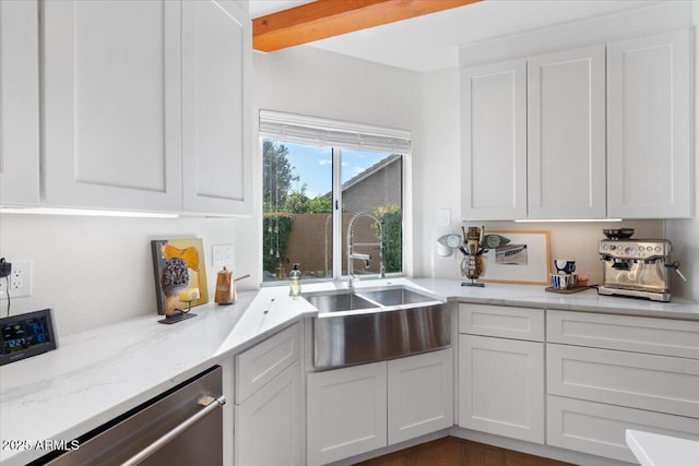 kitchen with white cabinets, light stone countertops, dishwasher, and sink