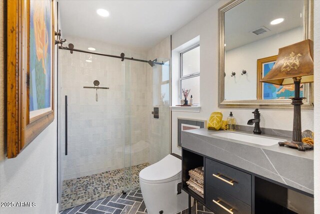 bathroom with walk in shower, vanity, and toilet