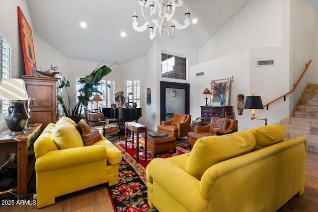 living room featuring a notable chandelier, dark hardwood / wood-style flooring, and high vaulted ceiling