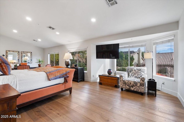 bedroom with light hardwood / wood-style flooring and vaulted ceiling