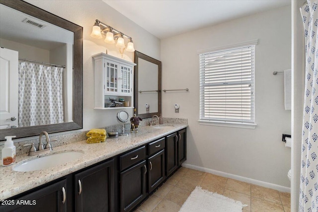 bathroom with tile patterned flooring, vanity, and toilet