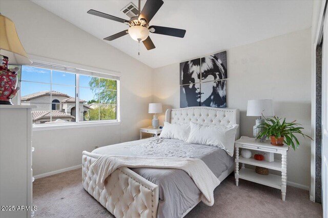 bedroom with carpet flooring, vaulted ceiling, and ceiling fan