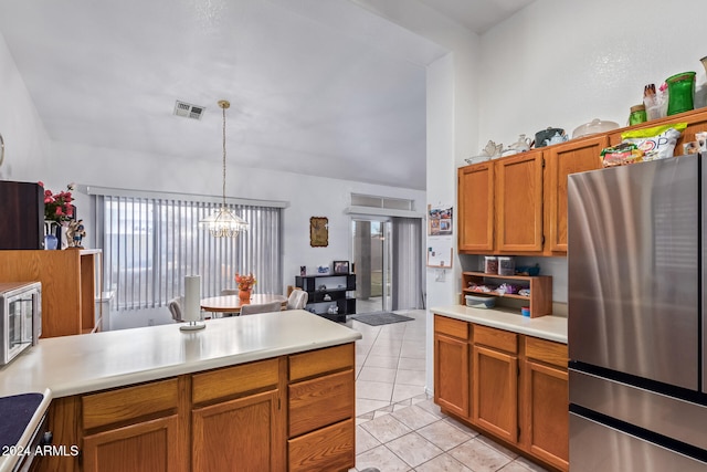 kitchen featuring an inviting chandelier, hanging light fixtures, light tile patterned flooring, and stainless steel fridge