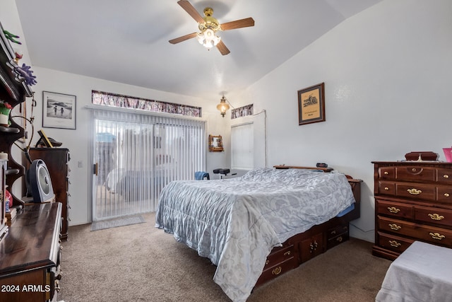 bedroom with vaulted ceiling, dark colored carpet, ceiling fan, and access to exterior