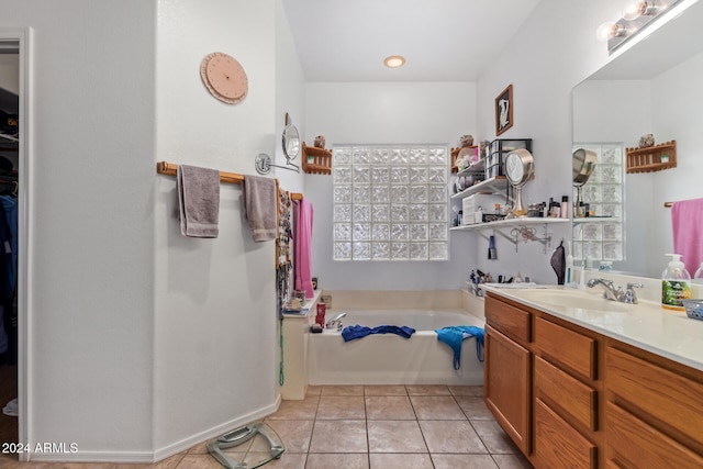 bathroom with tile patterned flooring, vanity, and a bathing tub