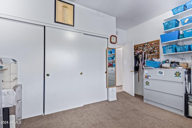 bedroom featuring light carpet and a closet