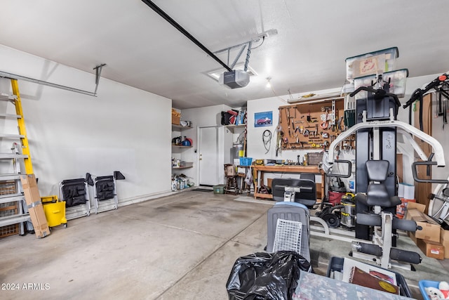 garage with a garage door opener and a workshop area