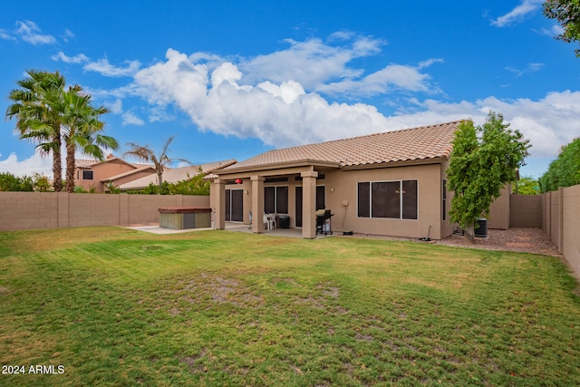 back of property featuring cooling unit, a yard, and a patio area