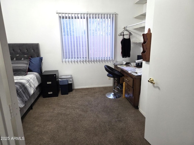 bedroom with baseboards and dark carpet