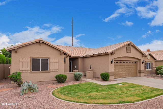 view of front of house featuring a garage and a front lawn