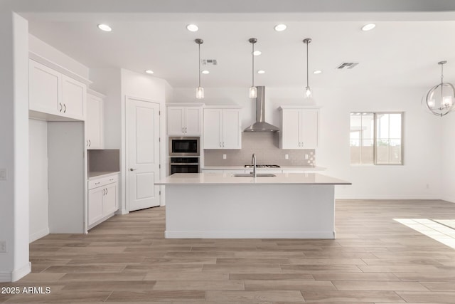 11660 W Luxton Ln, Avondale, AZ 85323 - kitchen featuring wall chimney range hood, oven, built in microwave, light countertops, and recessed lighting