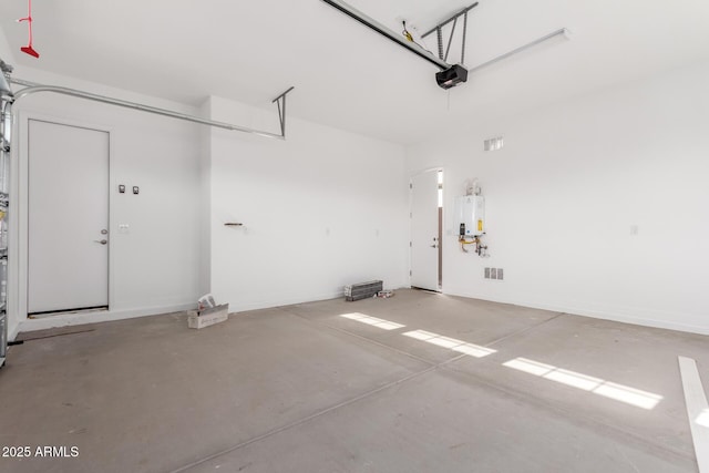 11660 W Luxton Ln, Avondale, AZ 85323 - garage featuring tankless water heater and a garage door opener