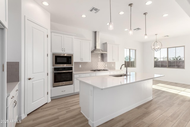 11660 W Luxton Ln, Avondale, AZ 85323 - kitchen with oven, wall chimney range hood, a sink, built in microwave, and gas stovetop