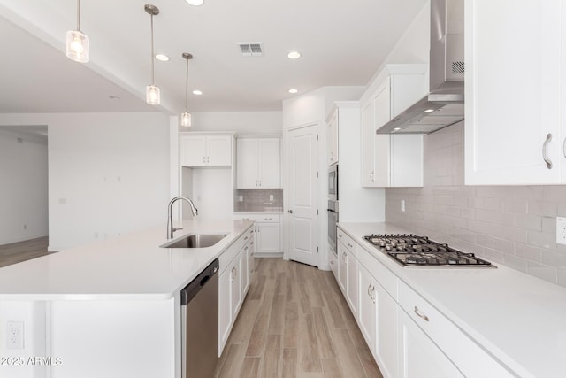 11660 W Luxton Ln, Avondale, AZ 85323 - kitchen with a sink, stainless steel appliances, wall chimney exhaust hood, recessed lighting, and white cabinetry