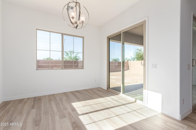 11660 W Luxton Ln, Avondale, AZ 85323 - unfurnished room with a chandelier, light wood finished floors, and baseboards