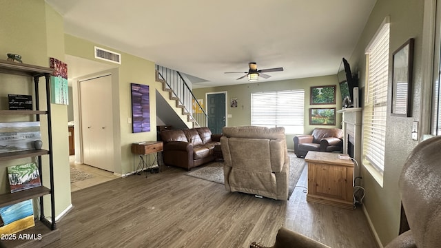 living room featuring hardwood / wood-style floors and ceiling fan