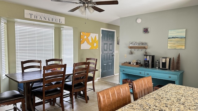 tiled dining space with ceiling fan