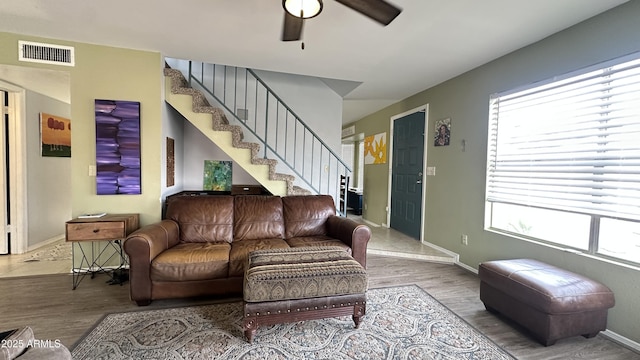 living room with wood-type flooring and ceiling fan