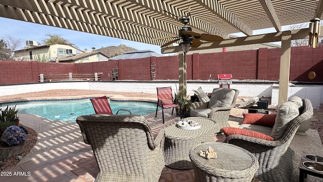 view of patio featuring a fenced in pool, a pergola, and ceiling fan