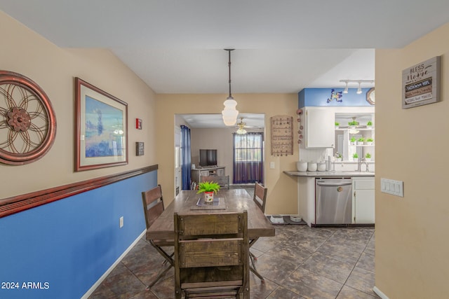 dining area featuring sink and track lighting