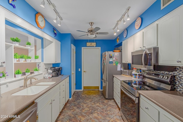 kitchen featuring track lighting, sink, white cabinetry, stainless steel appliances, and ceiling fan