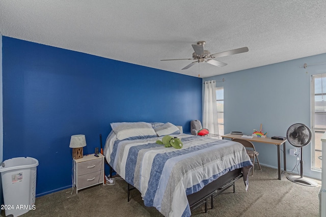 carpeted bedroom with ceiling fan and a textured ceiling