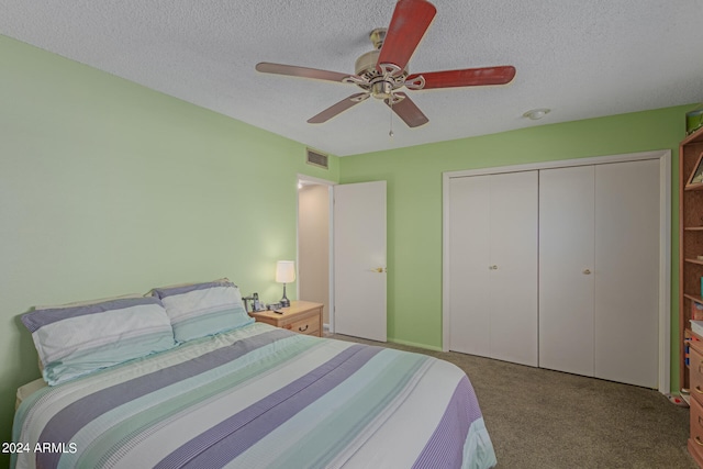 carpeted bedroom with ceiling fan, a textured ceiling, and a closet