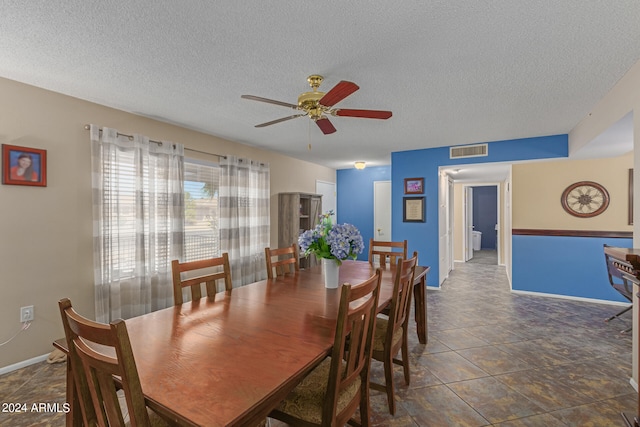 dining room featuring a textured ceiling and ceiling fan