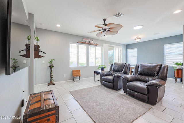 tiled living room featuring ceiling fan